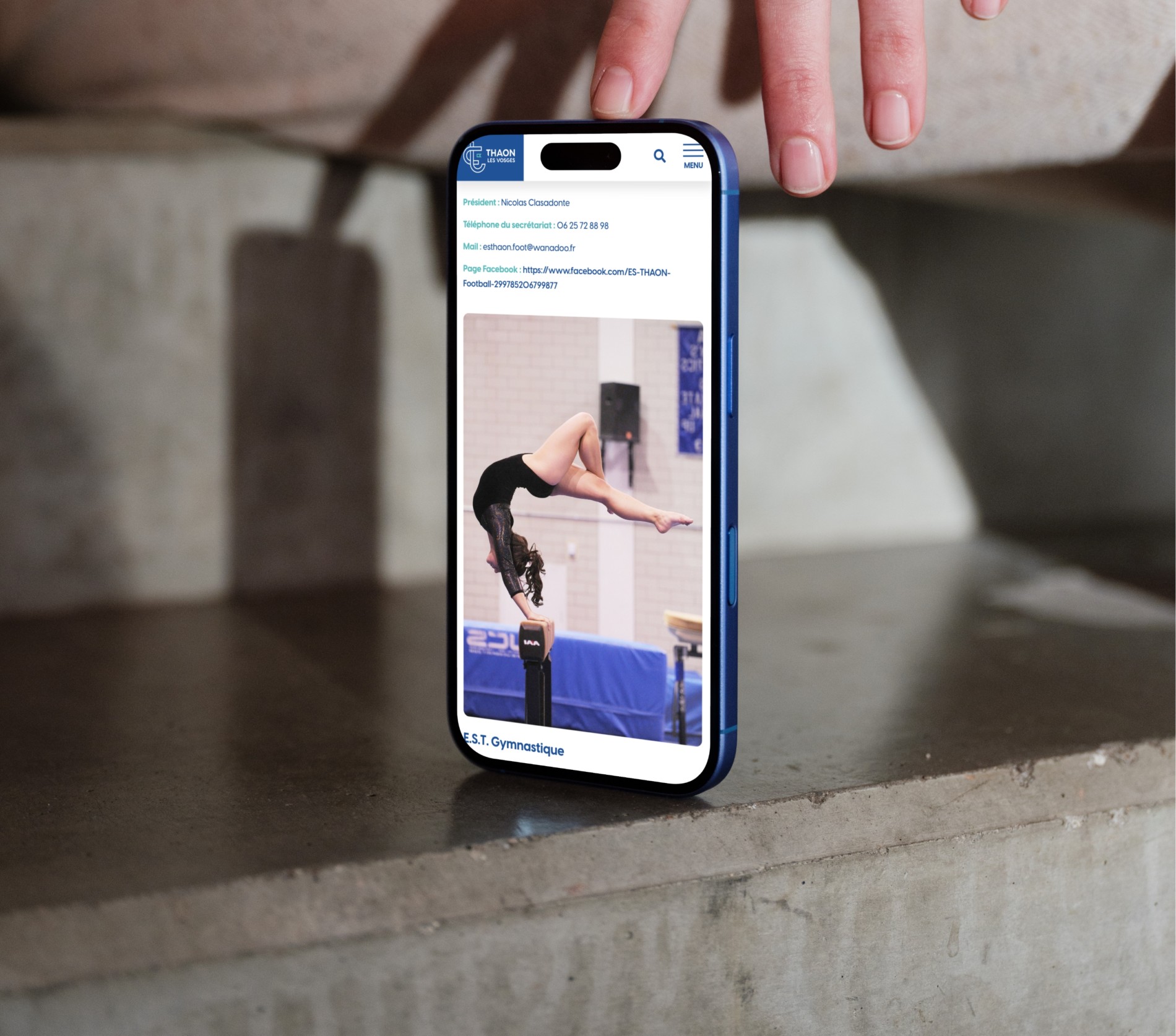 Mockuuups Iphone 16 Mockup On A Concrete Surface With Hand Detail