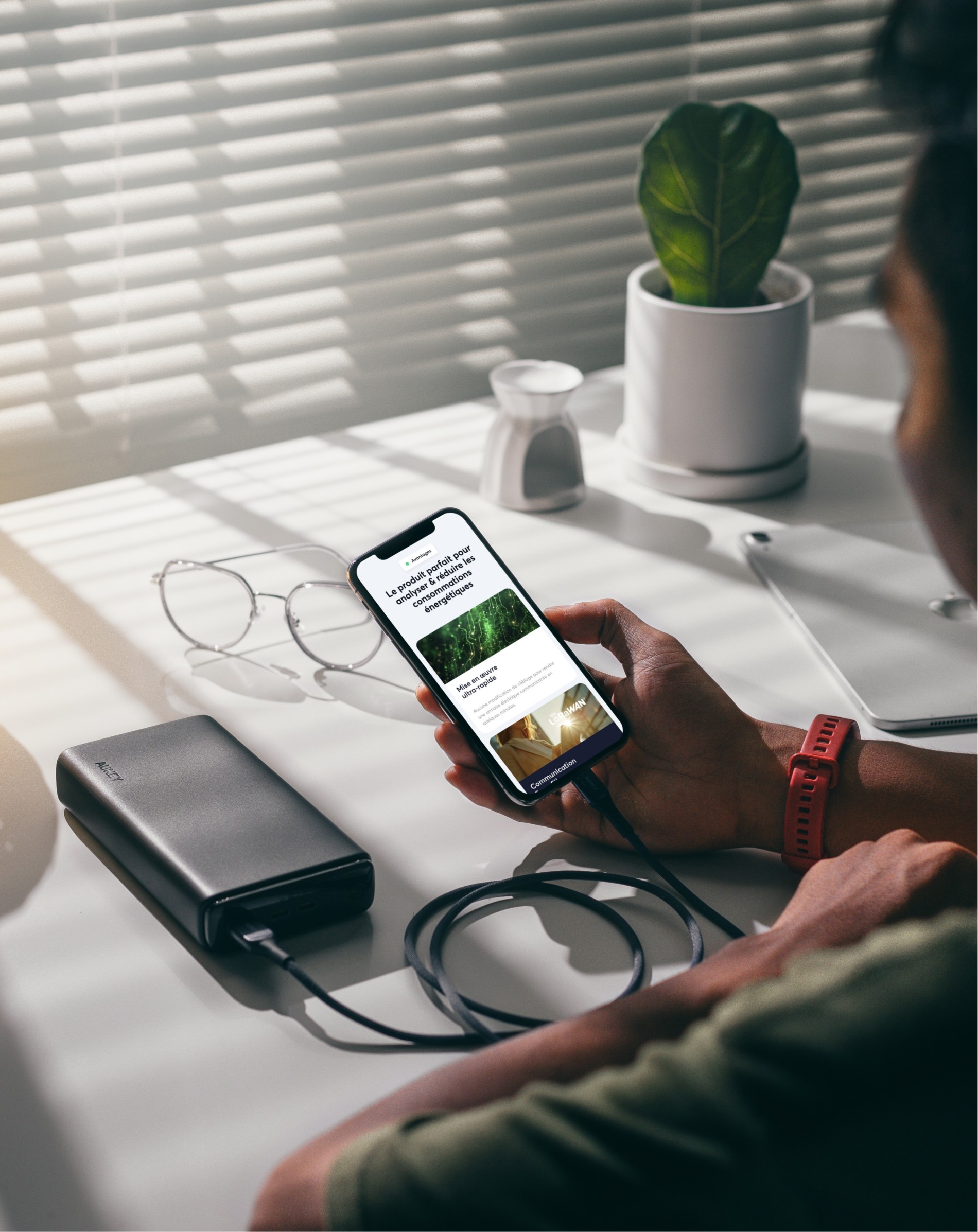 Mockuuups Man Holding An Iphone 12 Mockup Plugged Into A Power Bank